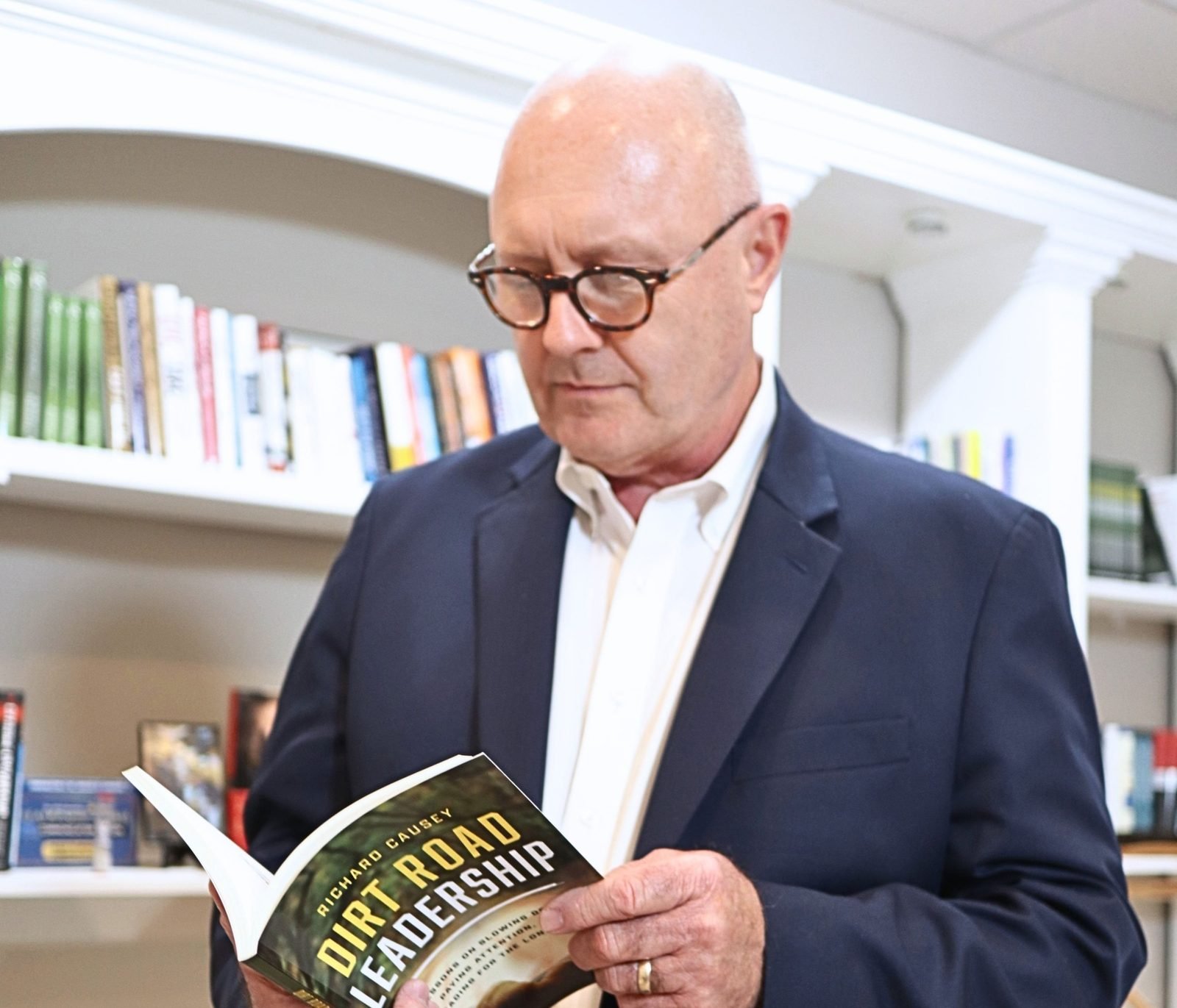 Richard Causey reading a copy of Dirt Road Leadership